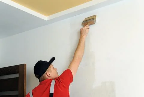 Worker adhesive wallpapers. Stock Photos