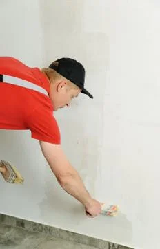 Worker adhesive wallpapers. Stock Photos