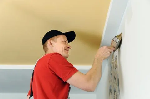 Worker adhesive wallpapers. Stock Photos