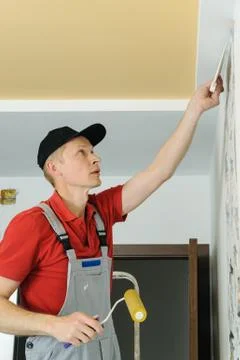 Worker adhesive wallpapers. Stock Photos