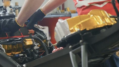 Worker adjust the air filter inside the motorbike Stock Footage 82148638