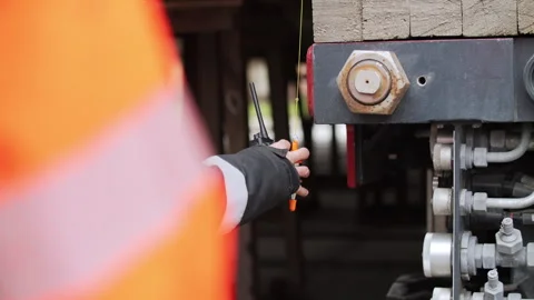 Worker adjusting alignment beacon on heavy transport platform Stock Footage 345080771