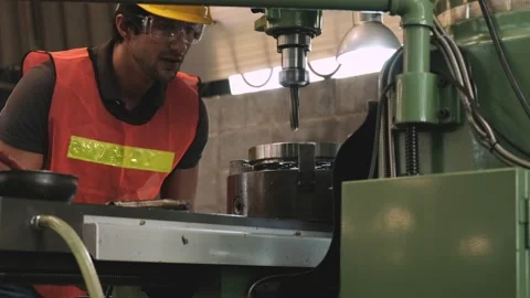 Worker adjusting and checking clearance of the workpiece in factory Stock Footage 130630040
