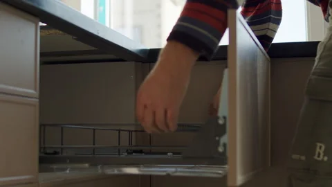 Worker Adjusting Drawer Mechanism During Kitchen Cabinet Installation Stock Footage 323911280