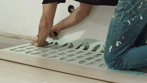 Worker Adjusting Foam Underlayment Sheet During Floor Installation Stock Footage 322055588