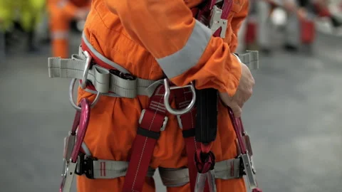 Worker adjusting safety harness during training Stock Footage 321408384
