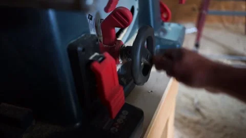 Worker adjusting the table saw blade height Stock Footage 309933161