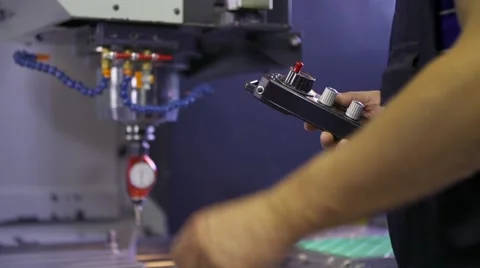 The worker adjusts calibration of cnc machine tool Видео 55012819