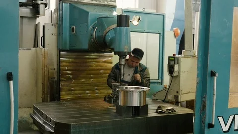 Worker adjusts drilling machine Stock Footage 101689426