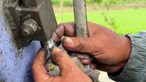 A worker adjusts the fastening point of a hydraulic connection on an excavator 動画素材 331445703