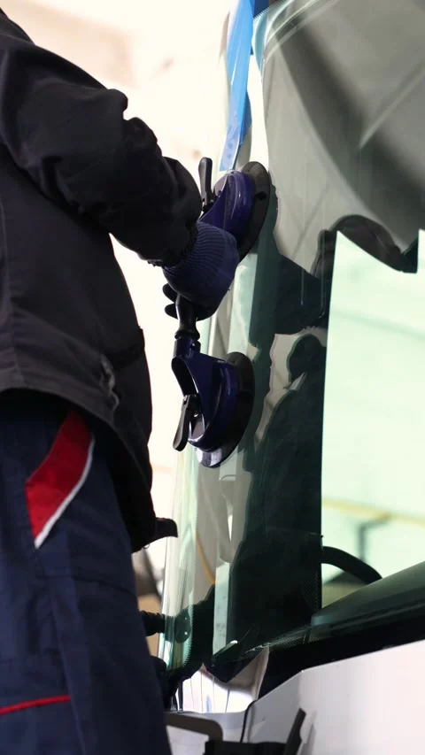 Worker adjusts glass with suction cup tool Stock Footage 335408720