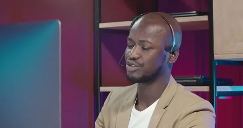 The worker adjusts the microphone on his headset Video stock 155057603