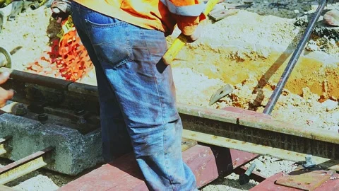 Worker adjusts the position of the rails of a track by adjusting the position Stock-Footage 144384480