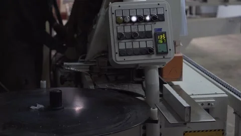 Worker adjusts the woodworking machine in the background. Stock Footage 145991907