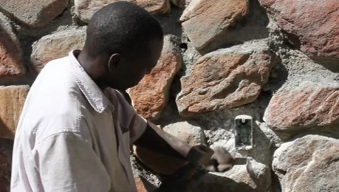Worker in Africa with Hammer and Chisel  (HD) Stock Footage 8830545