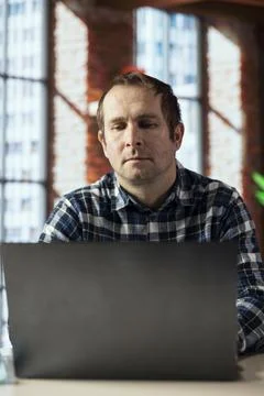 Worker analyzing data charts on laptop at desk, interpreting statistical graphs Stock Photos