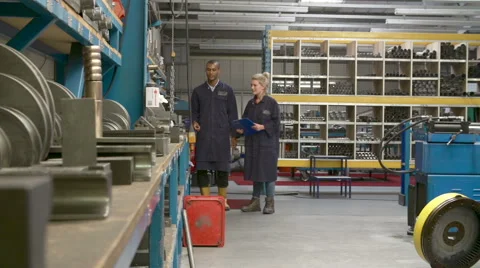 Worker And Apprentice Checking Stock Levels In Store Room Stock Footage