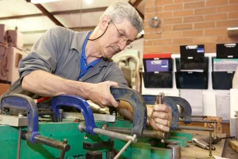 Worker and clamps Stock Photos