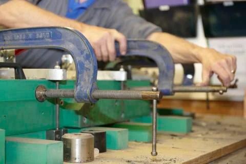 Worker and clamps Stock Photos