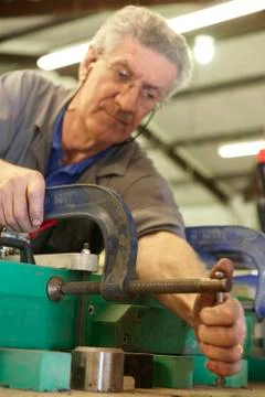 Worker and clamps Stock Photos
