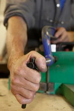 Worker and clamps Stock Photos