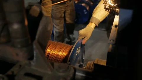 Worker and coil of copper cable at the cable production plant. Stock Footage 125665168