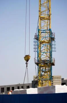 The worker and the crane operator unload the car with reinforced concrete wal Foto stock