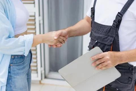Worker and customer shaking hands, finalizing agreement and building trust .. Stock Photos