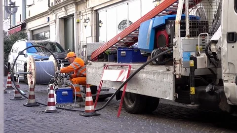 Worker and electrician at work to install fiber optic cables. Road works. Stock Footage 105231970