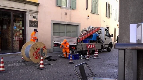 Worker and electrician at work to install fiber optic cables. Road works. Stock Footage 105232030