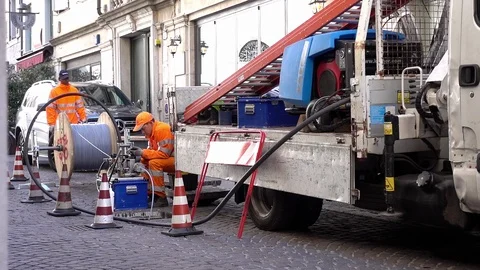 Worker and electrician at work to install fiber optic cables. Road works. Stock Footage 105232092