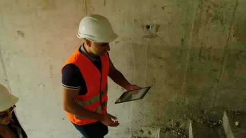Worker and engineer climb steps assessing work area Stock Footage 317618398