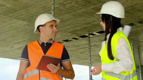 Worker and manager discuss work processes at construction site Video stock 317619282