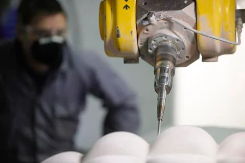 Worker and multi axis machine Stock Photos