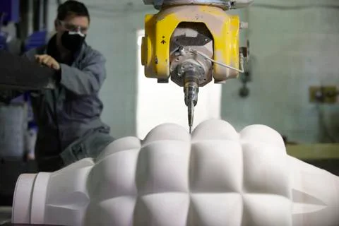 Worker and multi axis machine Stock Photos