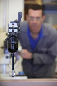 Worker and multisensor touch probe Stock Photos