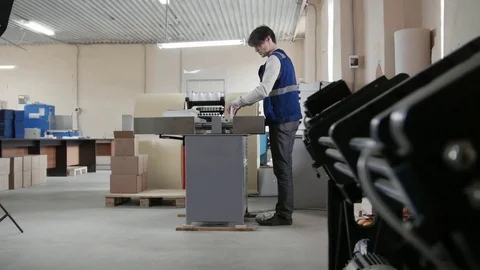 Worker and printing machine, polygraph industry Stock Footage