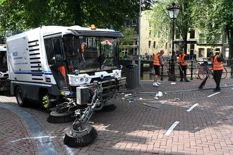 A worker and road sweeper machine clean street of Amsterdam. Stock Photos