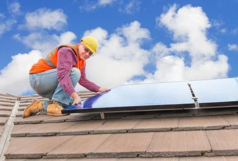 Worker and solar panels Photos