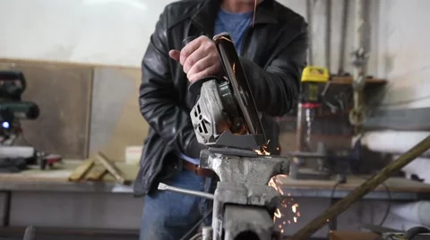 Worker with Angle Grinder does Metalworking in Industrial Environment Stock Footage 62064087