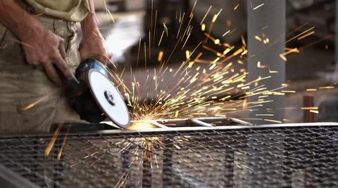 Worker with Angle Grinder does Metalworking in Industrial Environment. Stock Footage 64848253
