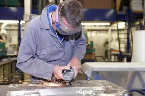 Worker with angle grinder Stock Photos