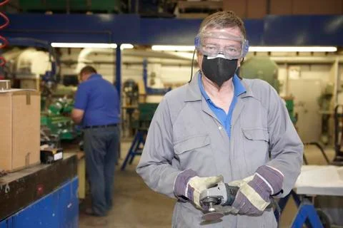Worker with angle grinder Stock Photos