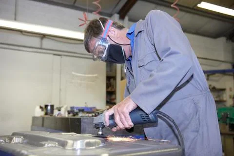 Worker with angle grinder Stock Photos