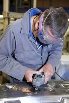 Worker with angle grinder Stock Photos