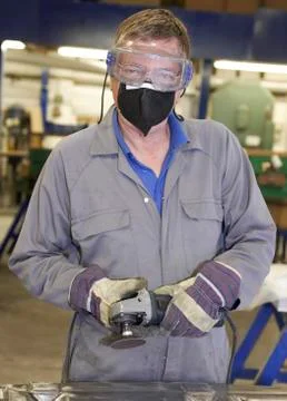 Worker with angle grinder Stock Photos