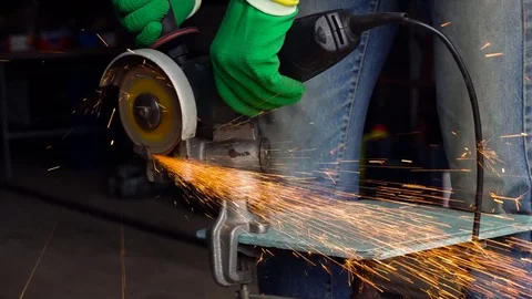 Worker with angular grinding machine is cutting the metal Stock Footage