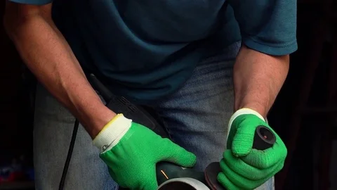 Worker with angular grinding machine is cutting the metal Stock Footage 76987873