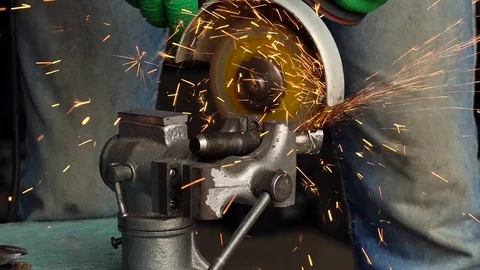 Worker with angular grinding machine is cutting the metal. Slow motion Vídeos de archivo 77906908