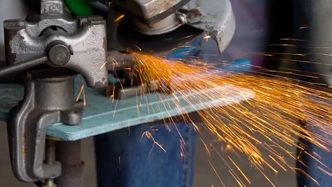 Worker with angular grinding machine is cutting the metal. Slow motion Stock Footage 78992343